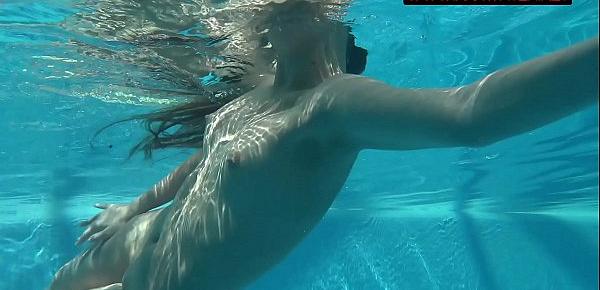  Small teen Mia Ferrari strips naked in pool